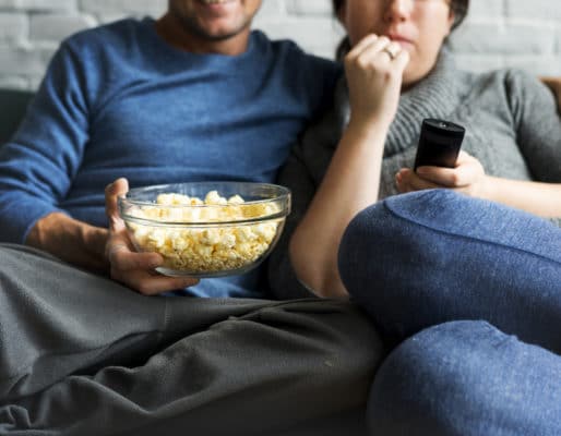 couple on couch eating popcorn