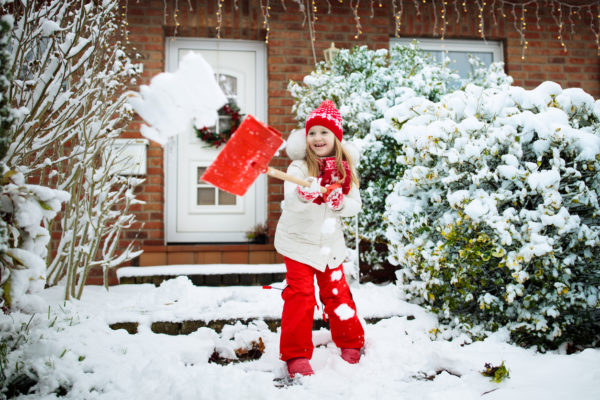 Little girl shoveling snow