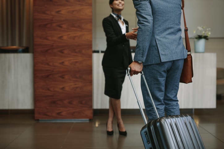 A hotel employee greets a guest.