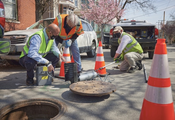 Professionals installing SMART in sewer