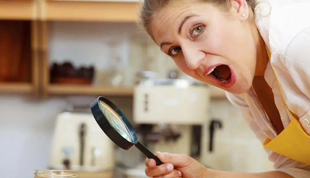 Surprised shocked mature woman female inspecting with magnifying glass.